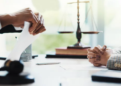 Contract being torn at legal desk representing broker breach of contract