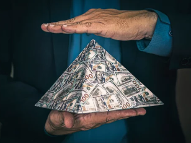 Money pyramid symbolizing Ponzi and investment pyramid schemes